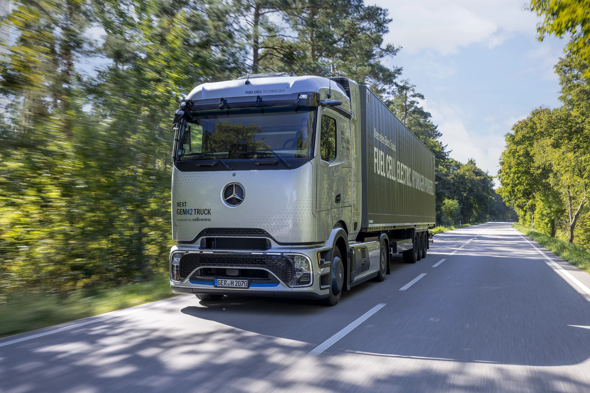 Mercedes-Benz NextGenH2 Truck hydrogen fuel-cell truck on a tree-lined road